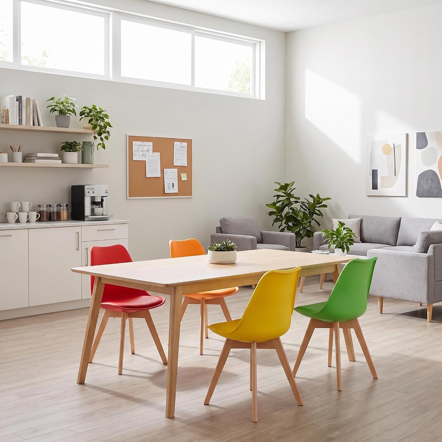 A modern dining area with a light wood rectangular table surrounded by five colorful chairs in red, orange, yellow, and green, set in a bright, contemporary living space with a gray sofa and plants.